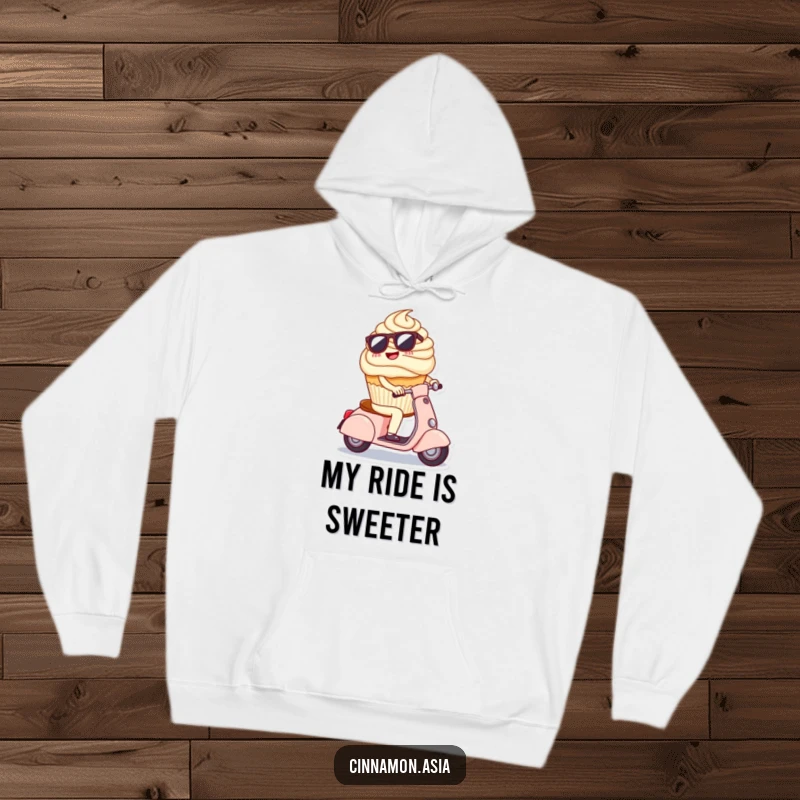 Funny hoodie featuring a cheerful cupcake in sunglasses, cruising on a tiny scooter with a carefree expression.